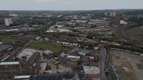 establishing aerial drone shot flying over edge of leeds city centre towards holbeck