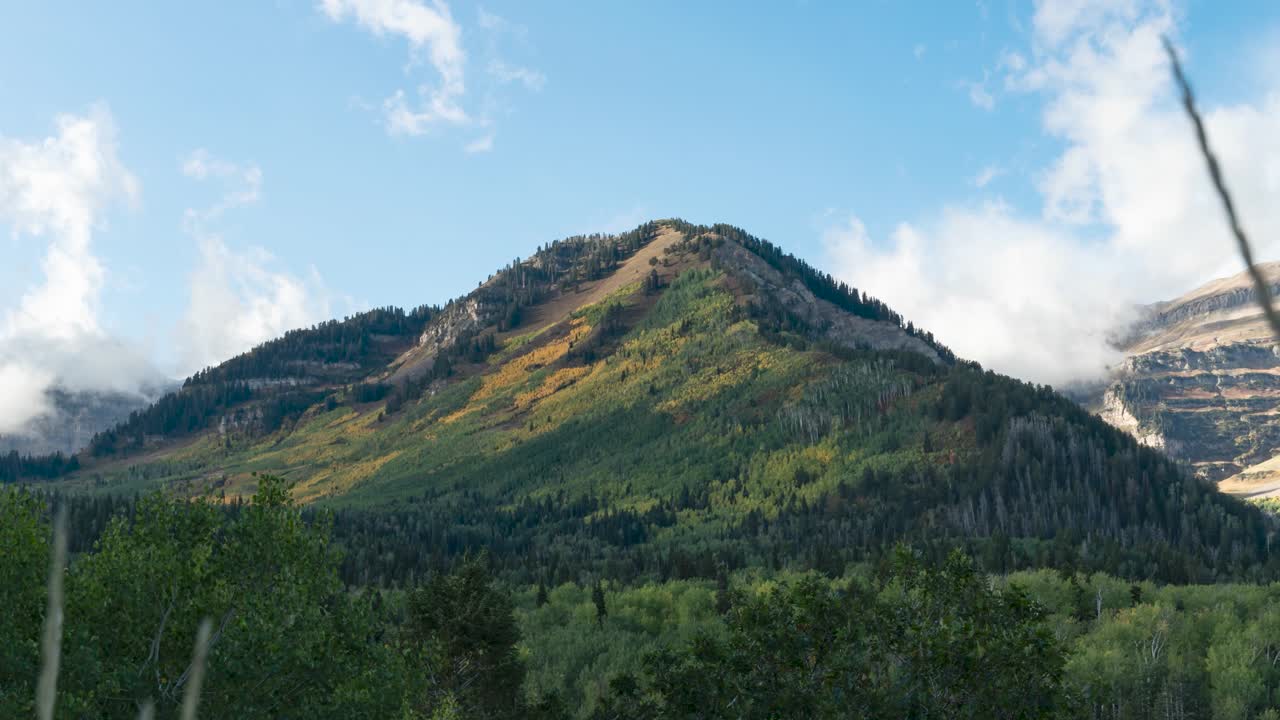 Autumn colors along the Wasatch Front mountains with low valley fog - panning time lapse