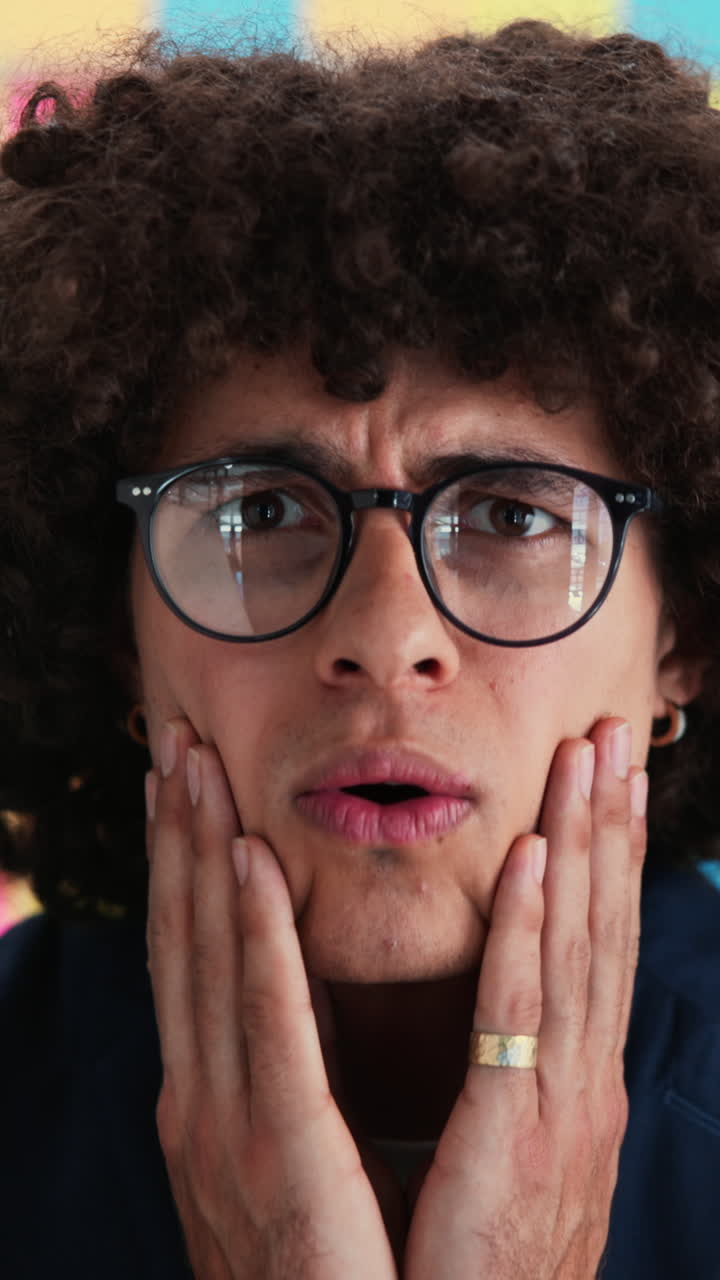 Close-up of Young Man Reacting with Surprise and Confusion