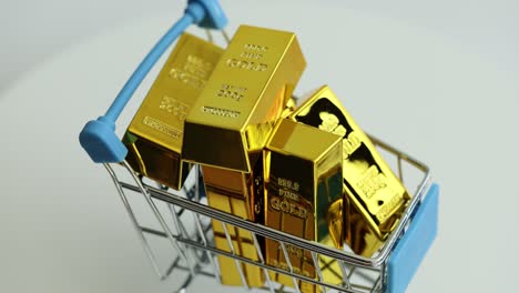 gold bars in a miniature shopping cart