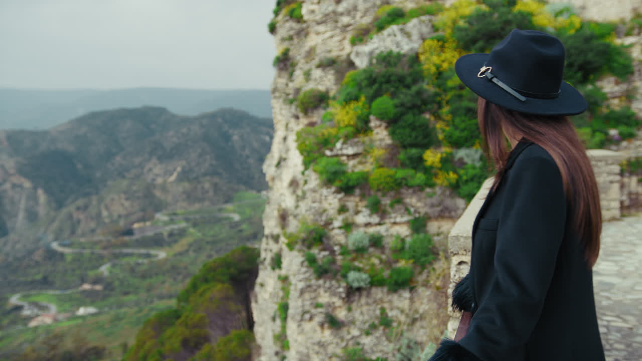 Woman Admiring The Beauty Of The Environment Down The Cliff