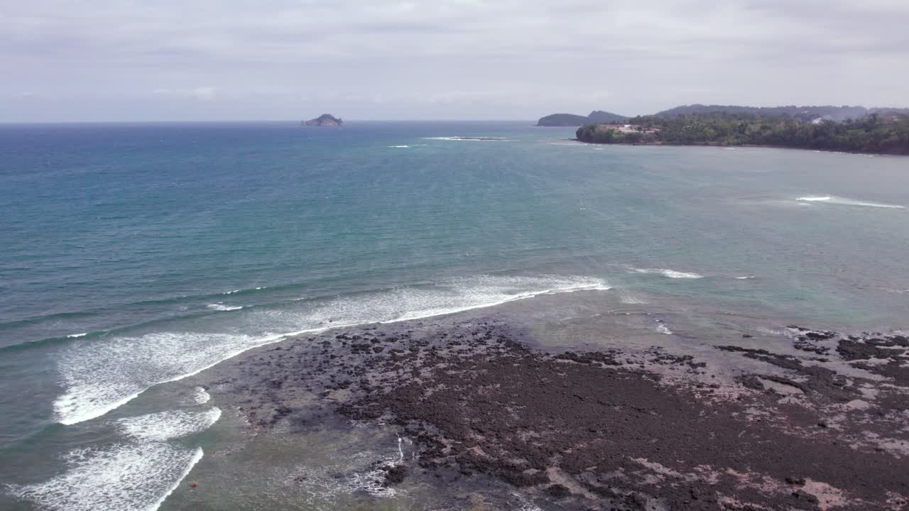 Scenic Tropical Beach with Palm Trees and Lava Rocks in São Tomé and Principe