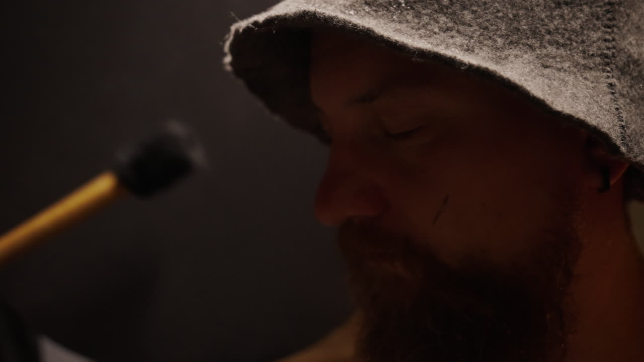 Man in Medieval Clothing in a Dark Studio