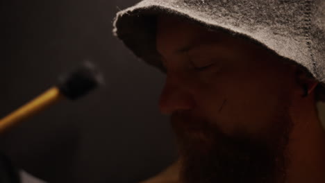 man in medieval clothing in a dark studio