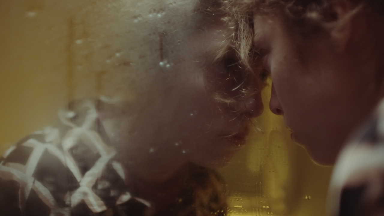 Sad Woman Leaning against Wet Mirror