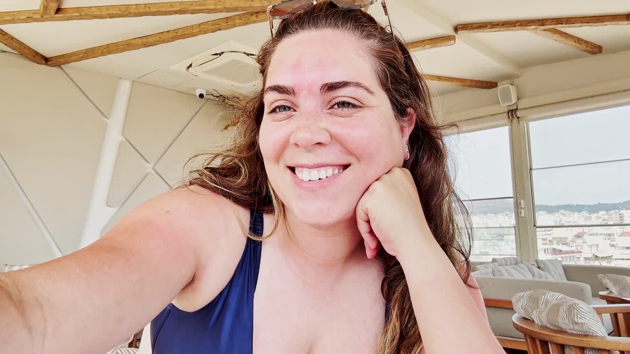 A Thoughtful Young Woman Relaxing in a Bright and Modern Lounge on Her Vacation