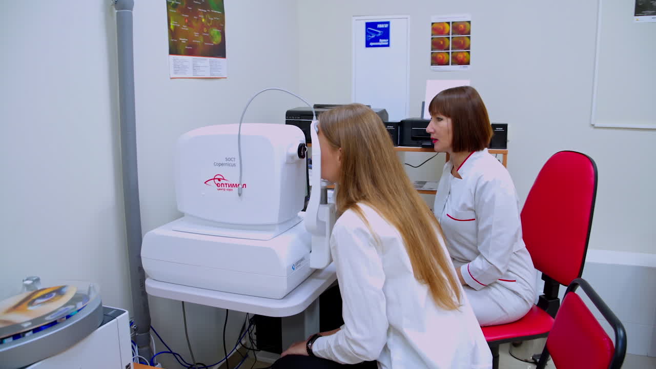 Patient in ophthalmology clinic. Female ophthalmologist talking with woman patient during medical consultation at the ophthalmologic office