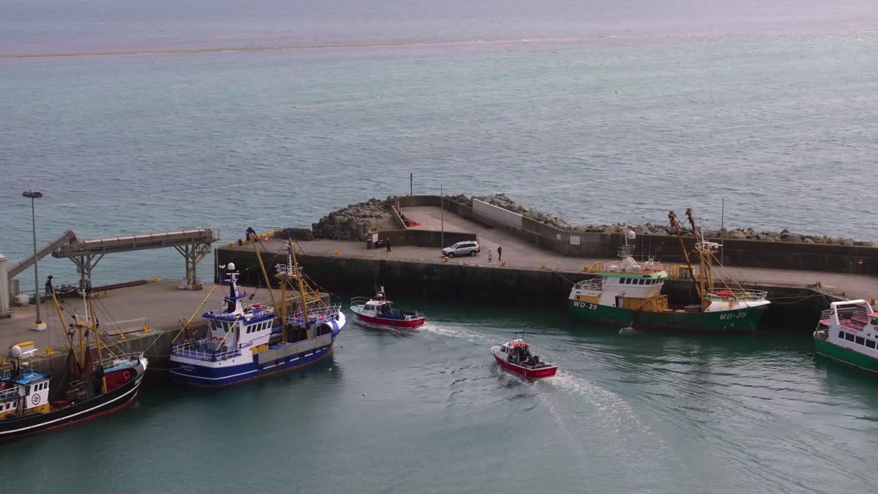 4K cinematic drone footage capturing Kilmore Quay, Co. Wexford, Ireland, on a bright day, showcasing the picturesque harbour, and colourful fishing boats Co.Wexford - Ireland_023