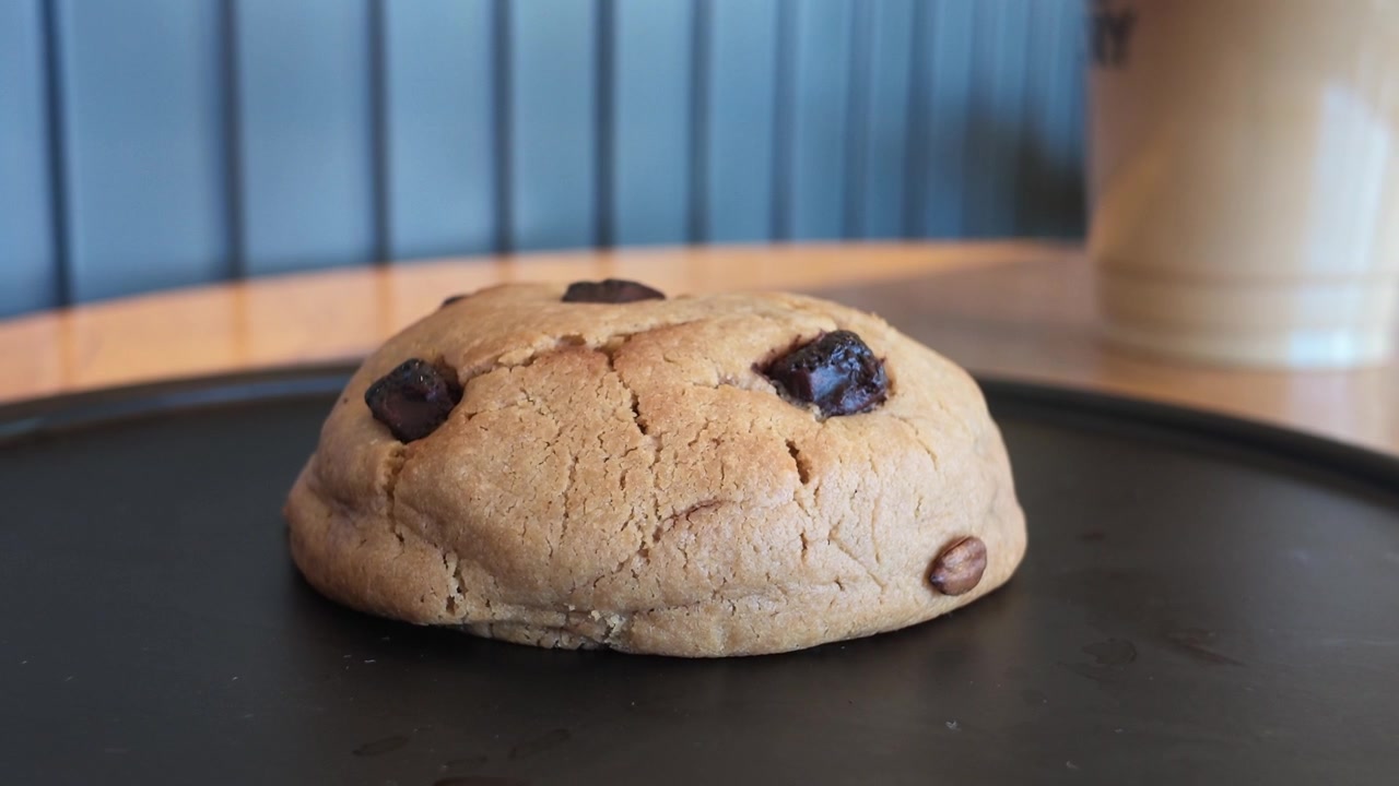 Freshly Baked Chocolate Chip Cookie on a Black Plate