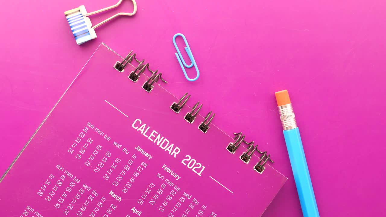 2021 Calendar with Office Supplies on Purple Desk