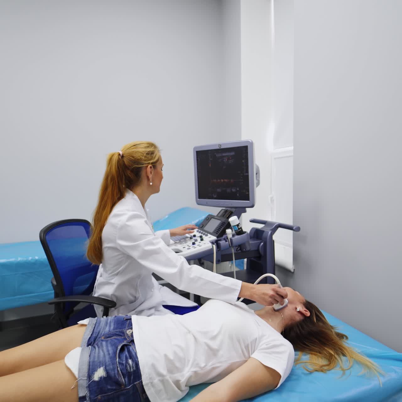 Ultrasound of thyroid gland of woman in hospital. Patient lies on the couch so the doctor could check her neck