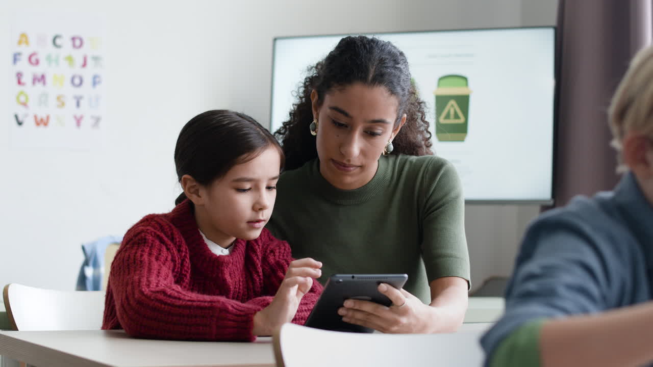 Teacher and Student Using Tablet in Classroom