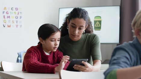 teacher and student using tablet in classroom