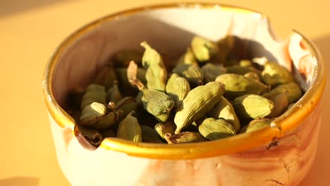 dried cardamom pods in a bowl