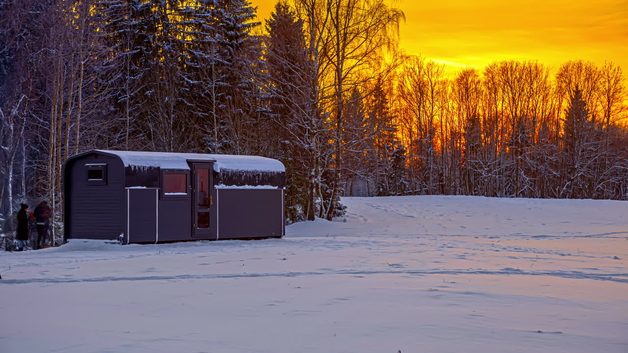 라트비아 리가 타임랩스의 눈 덮인 숲에 있는 작은 써모우드 캐빈