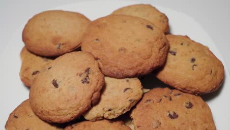 tilt down reveal of chocolate chip cookies on white background