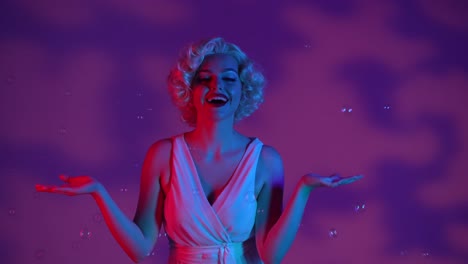young Woman Surrounded by Soap Bubbles in Studio on Pink Background with Highlights Illuminated by Young Woman Surrounded by Soap Bubbles in Studio on Pink Background with Highlights Illuminated by Pink and Green Neon Light Woman Looking Like Excitedly Saying Wow Emotion Joy Childhood