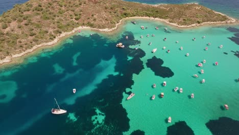 aerial view of a beautiful island with boats and turquoise water