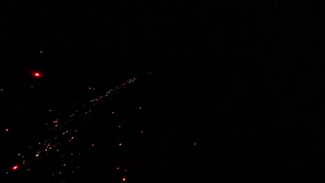 slow motion fireworks burst in night sky, colorful sparkling display