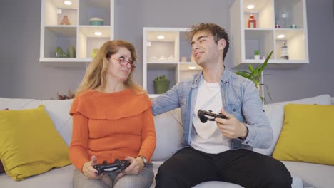 mother and son play video game.