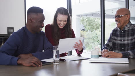 Happy-diverse-couple-and-financial-advisor-tablet-and-documents-at-home,slow-motion