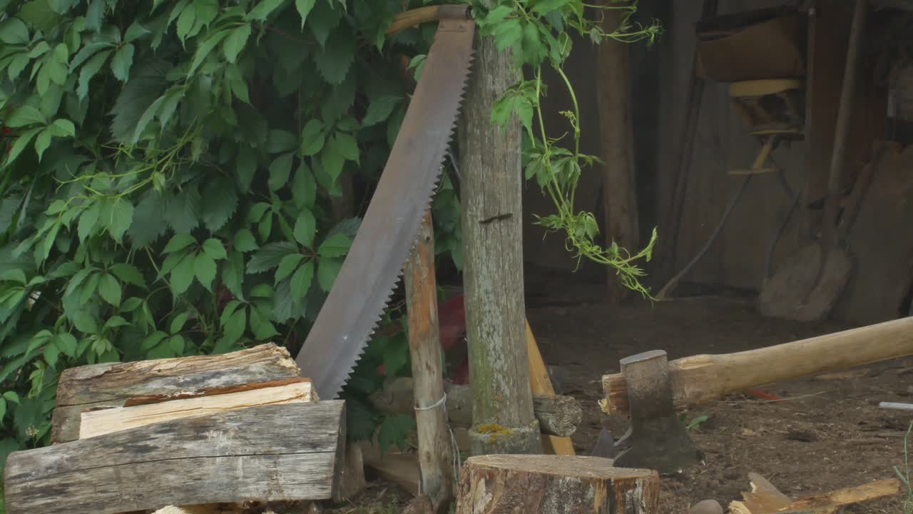 A Man With An Ax Splitting Firewood In The Village