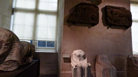 stone sculptures displayed in a museum room