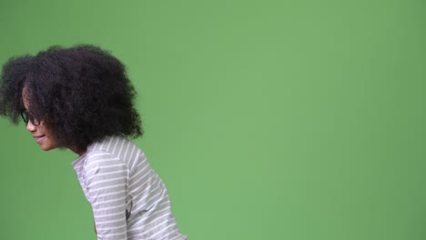 profile view of young cute african girl with afro hair laughing
