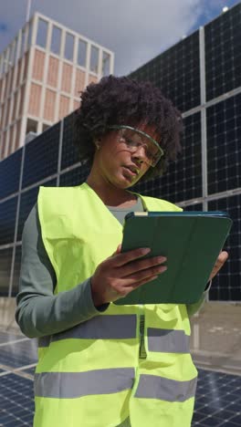 woman inspecting solar panels