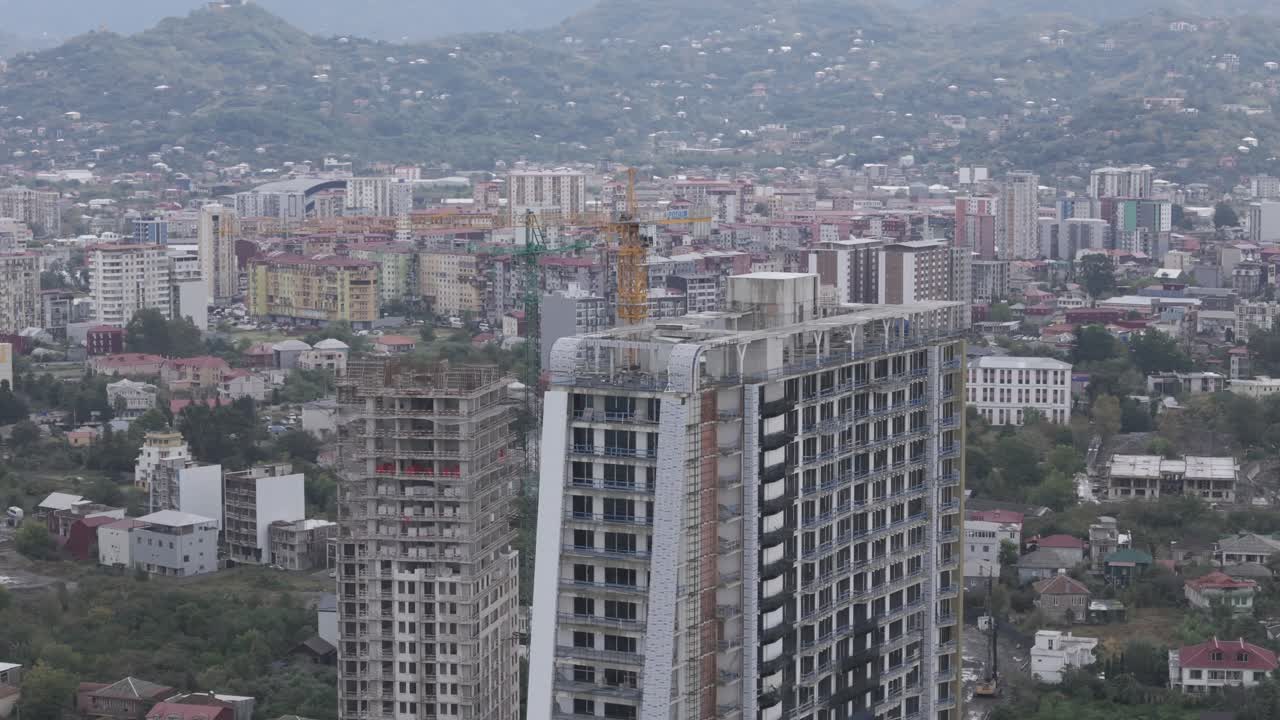 Cinematic daytime drone footage of Batumi traffic and tall buildings.