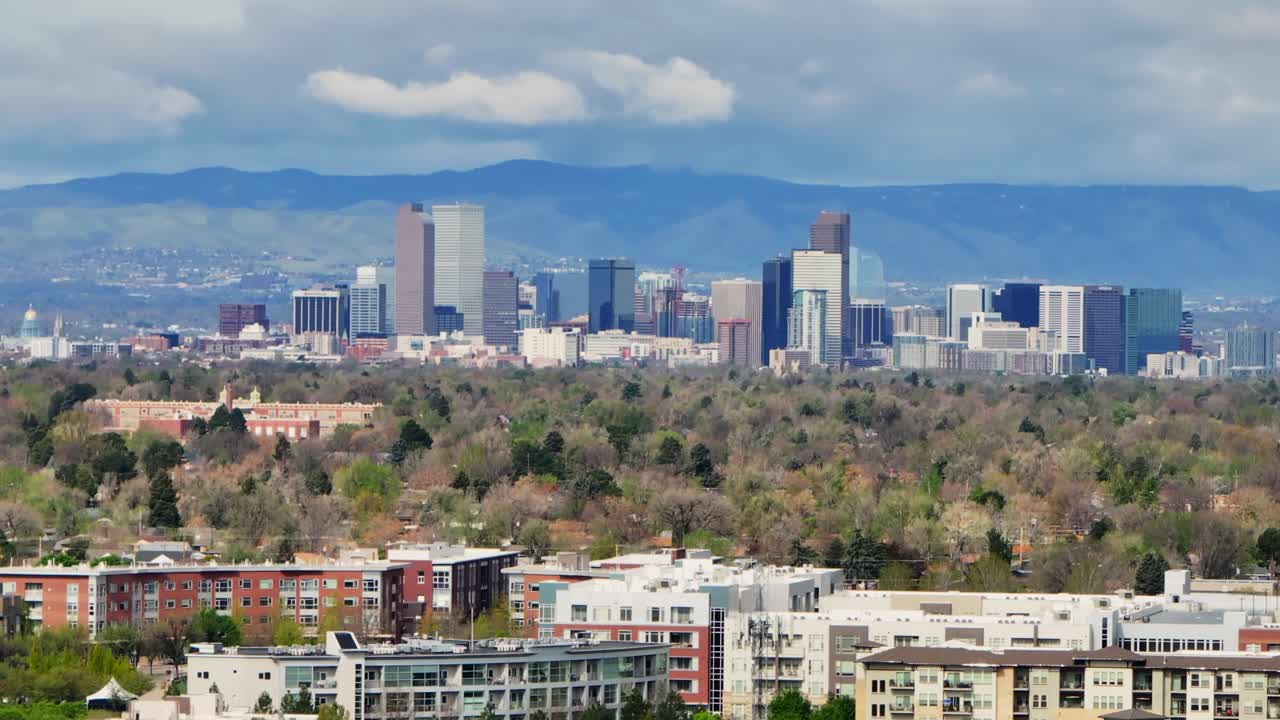 Downtown Denver skyscraper front range foothills landscape view aerial drone Colorado Northfield Stapleton Central Park spring morning rain clouds sunny cityscape Capitol building upwards motion