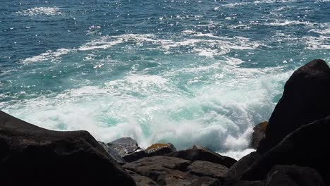 hd cámara lenta hawaii kauai estática de las olas del océano explotando bonito spray del océano con rocas de lava en primer plano