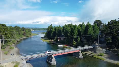 A-mesmerizing-river,-capturing-a-unique-perspective-of-a-thrilling-car-ride-across-a-bridge