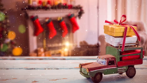 model car with christmas gifts and snow in a festive room.