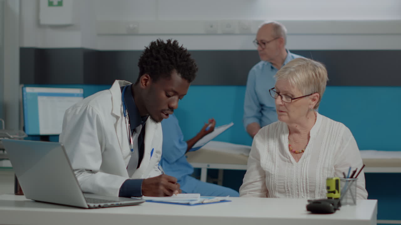 Doctor consulting with elderly patient