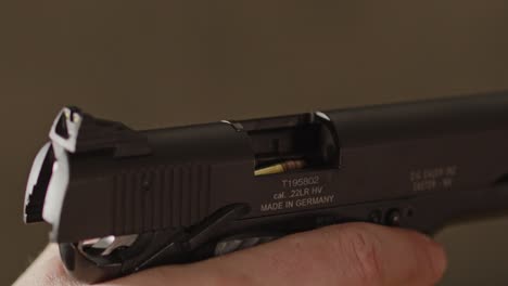 Close-up-of-open-pistol-with-a-bullet-ready-to-be-chambered