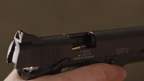 close up of open pistol with a bullet ready to be chambered