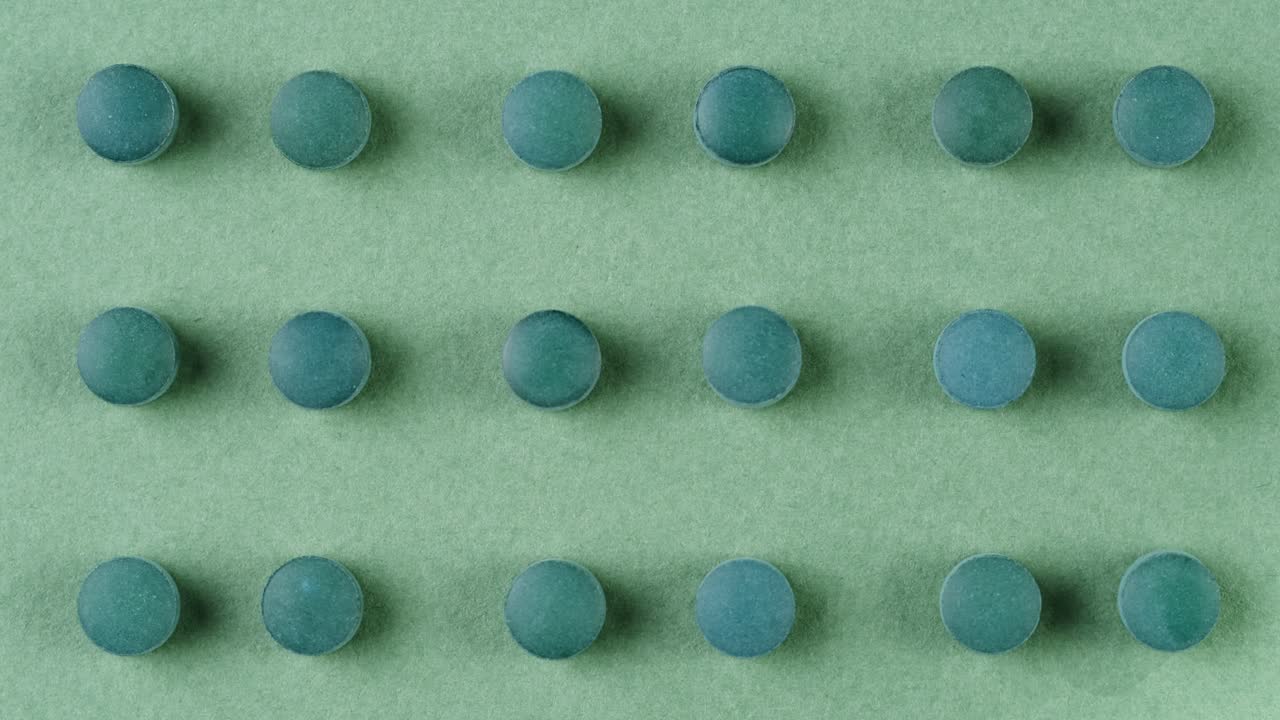 Green mint mentol lollipops, candies, bonbons disappear on purple background. Summer bright texture studio shot for store, supermarket, close up top view. Children favorite sweets made of sugar.