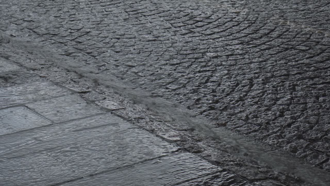 Rain Pours Down Along The Old Town With Cobblestone Streets In Bergen, Norway. Close-up Shot