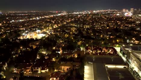 Establishing-shot-between-buildings-in-Century-City,-California-USA,-early-morning-aerial-with-city-lights