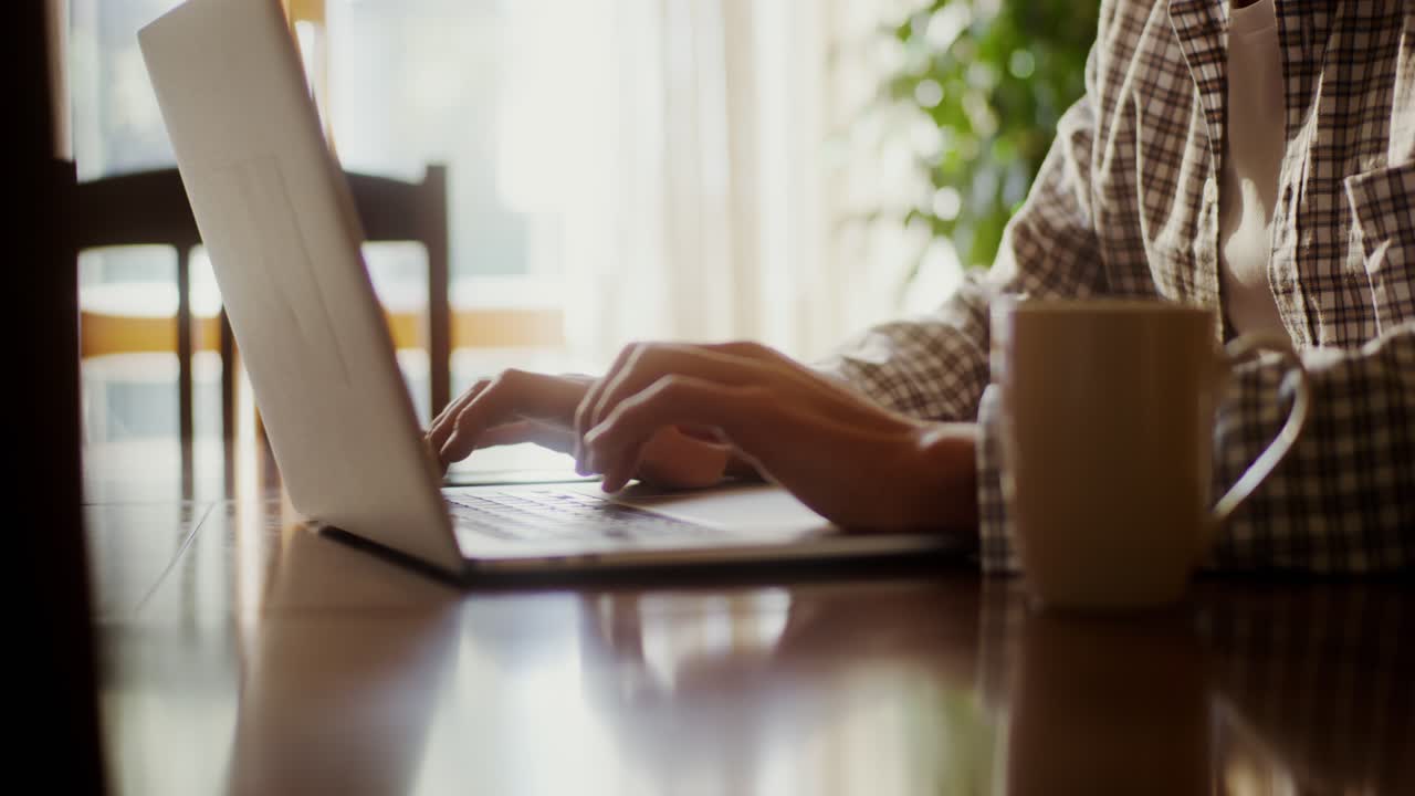 Person Working on Laptop with Coffee