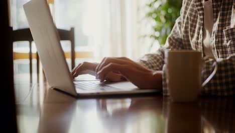 person working on laptop with coffee