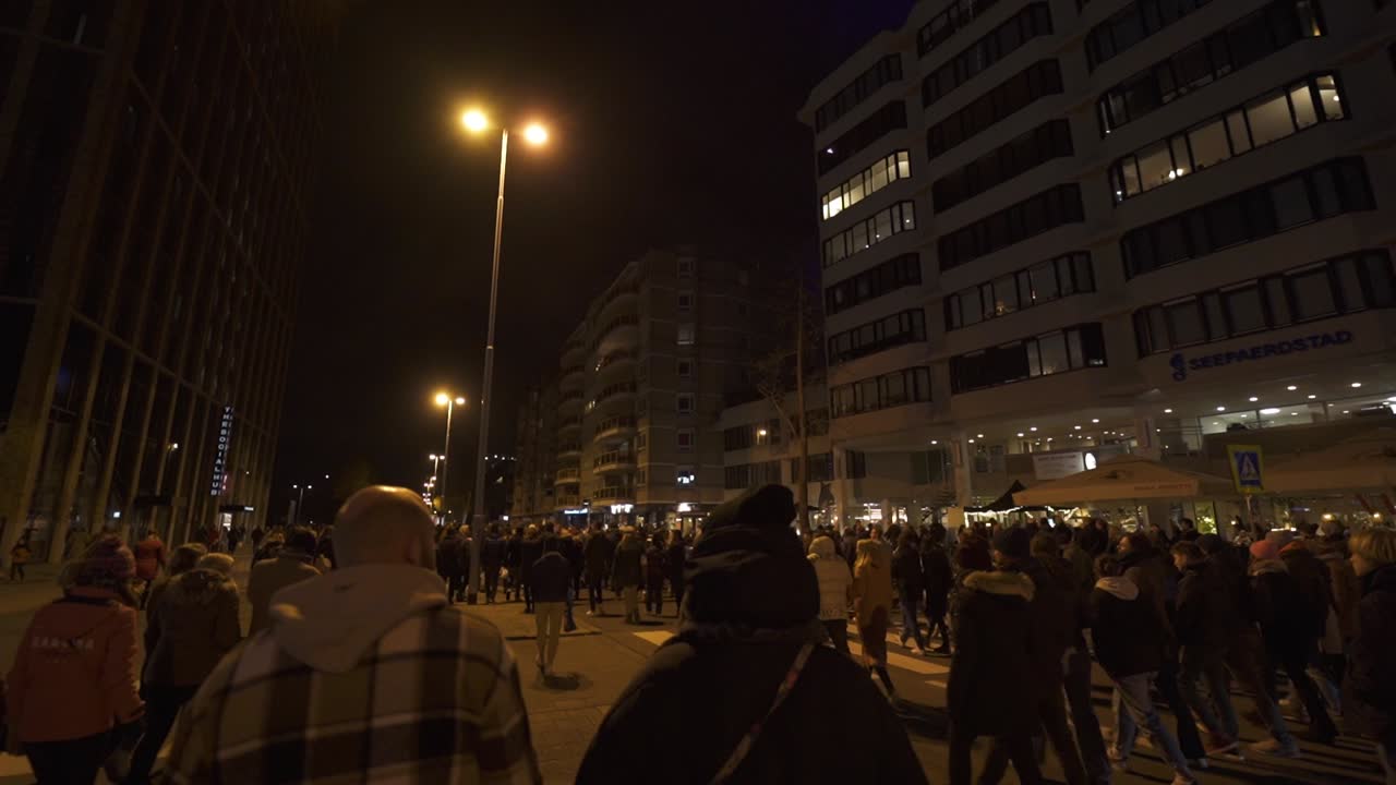 Crowd of people walking in downtown Eindhoven during night time, Glow Festival