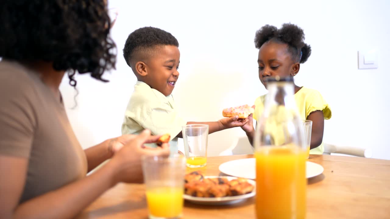 Family Enjoying Donuts and Juice Together