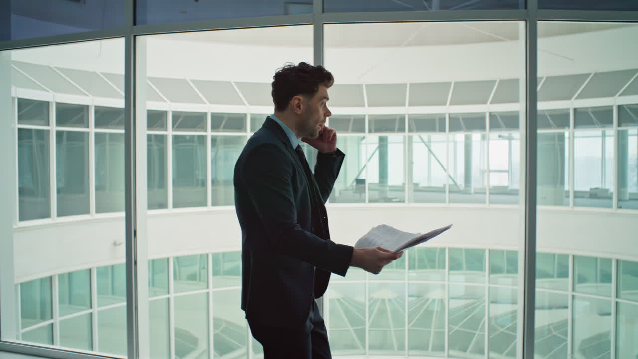 Emotional boss shouting telephone walking office corridor. Furious executive
