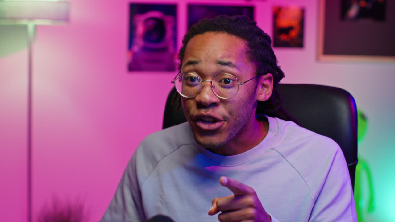 Young black man talking to camera, smiling and looking confident