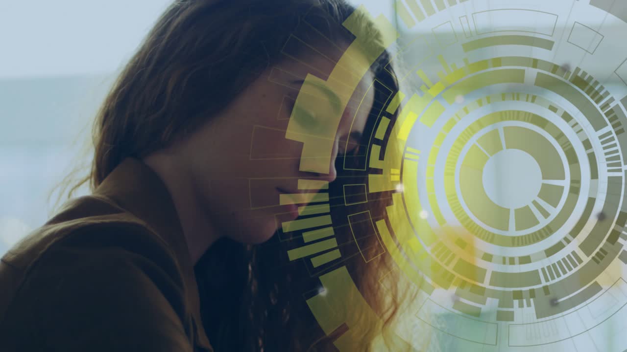 woman tapping smartwatch on wrist and typing on laptop by window, showing business data HUD
