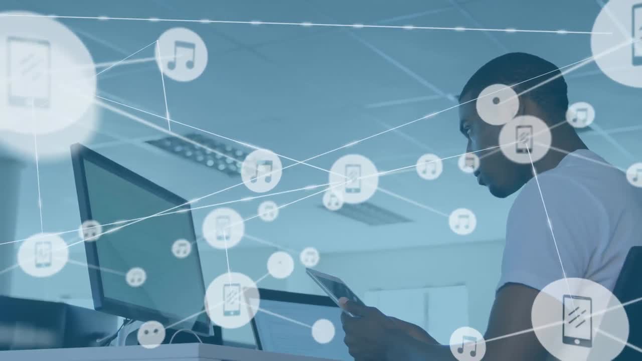 Animation of connected icons over low angle view of african american man using technology in office