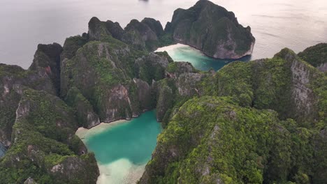 lagoon reveal over the clouds, captured by drone. phi phi islands, thailand. dramatic landscape