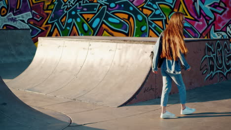 young woman in denim walking through a vibrant graffiti-filled skatepark
